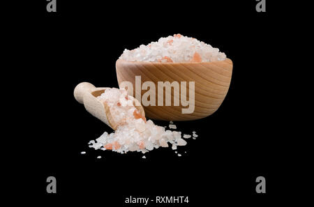 Himalaya Pink salt in Houten und Schaufel auf schwarzen Hintergrund isoliert. Gewürze und Zutaten. Stockfoto