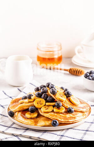 Pfannkuchen mit Banane, Blaubeeren auf weiße Platte, selektiven Fokus. Stockfoto