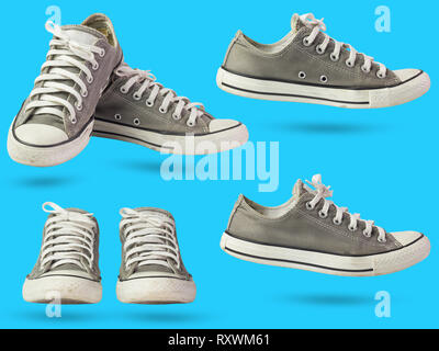 Satz von dreckigen sneakers Festlegung auf blauem Hintergrund isolieren. Stockfoto