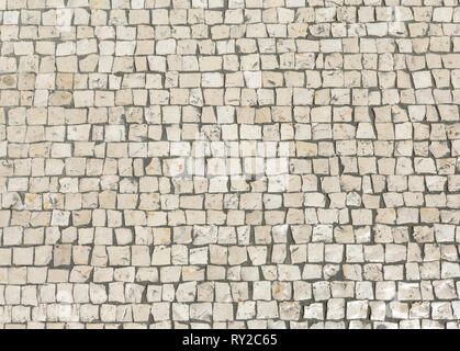 Mosaik Fertiger von kleinen Steinen. Zusammenfassung Hintergrund der alten Kopfsteinpflaster close-up. Stockfoto