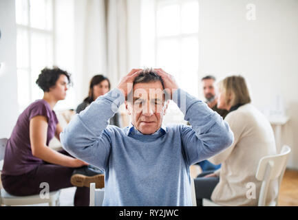 Eine Taille-up Portrait von älteren depressiven Mann während der Therapie. Stockfoto