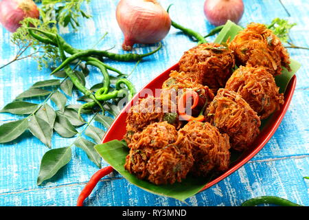 Indische Küche - knusprig gebratener onin Krapfen, Ulli Vada, pakkoda, pakora Stockfoto