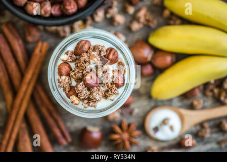 Mit Joghurt mit Müsli, Bananen und Nüsse Stockfoto