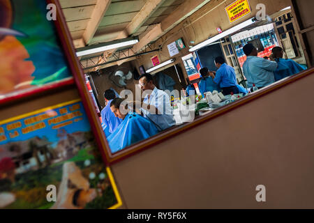Salvadorean Friseure schneiden Haare Kunden in einem vintage Barber Shop in San Salvador, El Salvador. Stockfoto