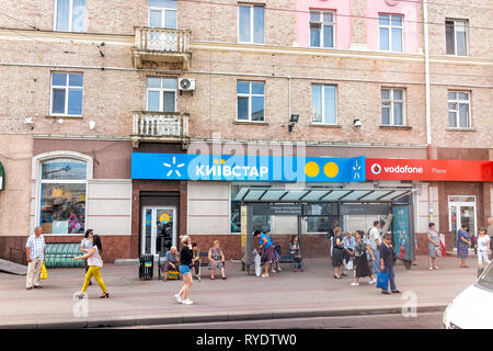 Riwne, Ukraine - August 21, 2018: Straße mit Telefon service provider Store anmelden Kyivstar und Vodafone mit vielen Menschen auf Pflaster shop Stockfoto