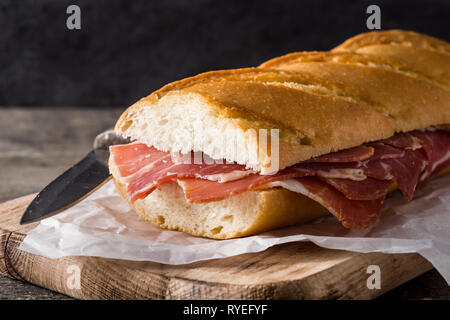 Spanischer Serrano Schinken Sandwich auf Holztisch. Stockfoto