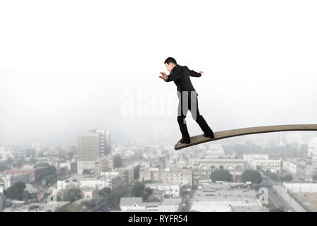 Unternehmer Balancieren auf Holzbrett mit städtischen Szene Hintergrund Stockfoto