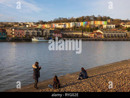 Drei Mädchen auf ihren cellphones am Ufer des schwimmenden Hafen, Bristol Stockfoto