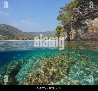 Spanien an der felsigen Küste in der Nähe von Cala Montjoi, geteilte Ansicht Hälfte über und unter Wasser, Mittelmeer, Costa Brava, Katalonien Stockfoto