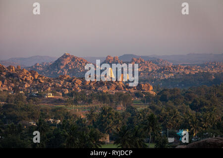 Die Felsbrocken von Hampi mit virupaksha Temple bei Sonnenuntergang in Hampi Stockfoto