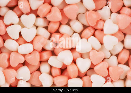 Ganz in der Nähe auf kleinen herzförmigen Bonbons. Valentinstag Grußkarten-Konzept. Stockfoto