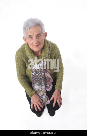 Blick von oben auf eine ältere Frau sitzt auf einem Stuhl Stockfoto