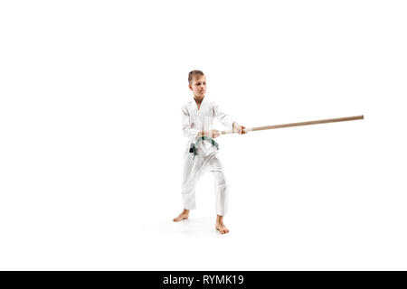 Jugendlich junge Kampf mit holzschwert an Aikido Training in Martial Arts School. Gesunder Lebensstil und Sport Konzept. Fightrer in weißen Kimono auf weißem Hintergrund. Karate Mann in Uniform. Stockfoto