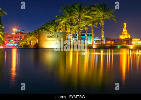 Doha, Katar - Februar 20, 2019: Museum für Islamische Kunst Zeichen und Fanar Islamischen Kulturzentrum reflektiert in Brunnen Wasser in der Nähe der Corniche an Stockfoto