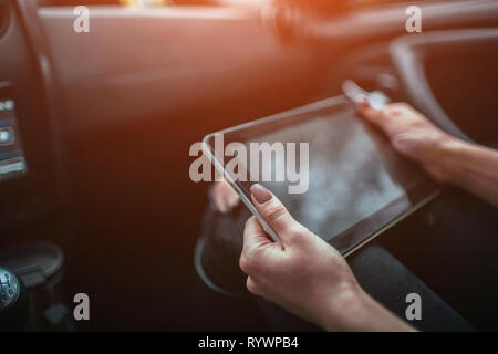 Frauen, die mit Hilfe von GPS auf Tablet compter im Auto in den Urlaub zu navigieren. Stockfoto