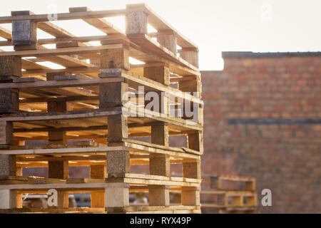 Im freien Hintergrund der Lager Holz- versand Paletten übereinander für industrielle Transport recycling Depot gestapelt. Stapel von Euro Stockfoto