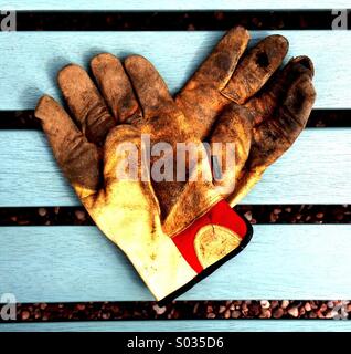 Gartenhandschuhe auf Bank Stockfoto