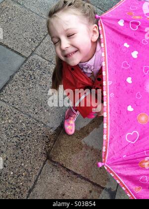 Kleine Mädchen genießen den Regen Stockfoto