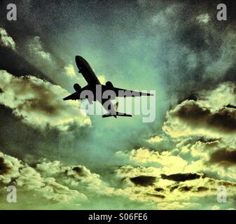 Ein Flugzeug in einem wolkigen Himmel abheben Stockfoto