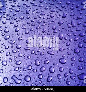 Regentropfen Muster auf bunte Autodach Stockfoto