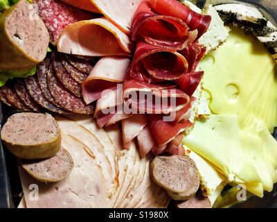 Frühstücksteller mit verschiedenen Arten von Käse und Fleisch schneidet Stockfoto