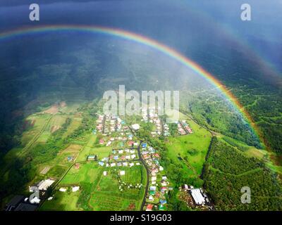 Irgendwo über dem Regenbogen mit ein Luftbild von Hilo auf Big Island von Hawaii Stockfoto