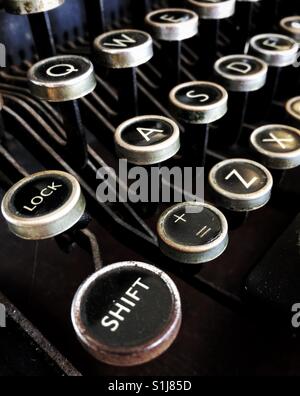 Die Shift-Taste und andere Tasten auf der QWERTZ-Tastatur eine altmodische, Imperial, schwarz / weiß-Schreibmaschine. Stockfoto