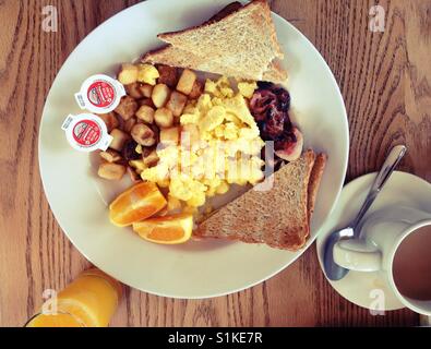 Amerikanisches Frühstück mit Speck, Eiern, Toast und Rösti.  Frühstück in einem Diner. Stockfoto