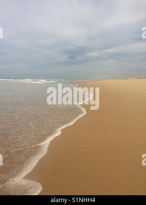 Wellen waschen bis auf den Strand Stockfoto