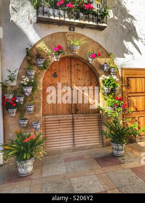 Ein Stadthaus mit Blumentöpfen um die Tür und auf dem Balkon in der Altstadt von Javea/Xabia, Alicante, Spanien eingerichtet Stockfoto