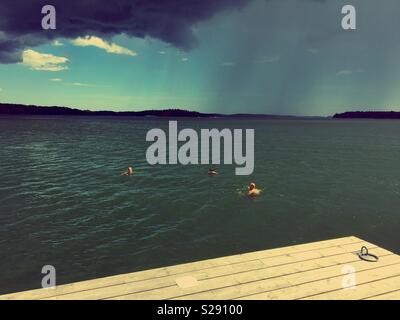 Männer nehmen eine in Schwedischen Hitzewelle mit Regen brauen Schwimmen Stockfoto