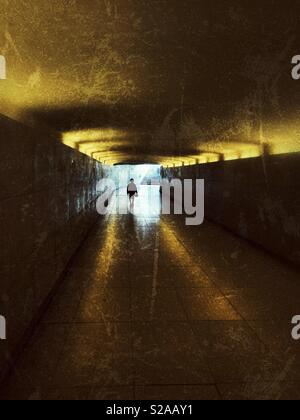 Junge wandern einen Tunnel mit dem Licht am Ende Stockfoto