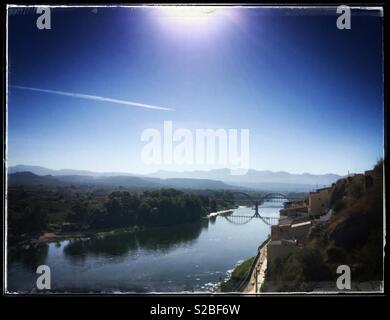 Blick über den Fluss auf die bogenförmige Brücke, Mora d'Ebre, Katalonien, Spanien. Stockfoto