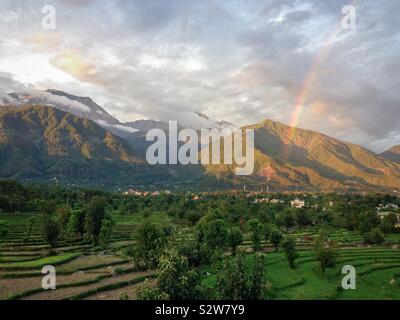 Helle Sonne Strahlen des Lichts und der Monsun Wolken über die grünen Berge des Dhauladhar reicht in den Ausläufern des Himalaya, in der Nähe von Dharamsala, einem beliebten Urlaubsziel in Himachal Pradesh Indien Stockfoto
