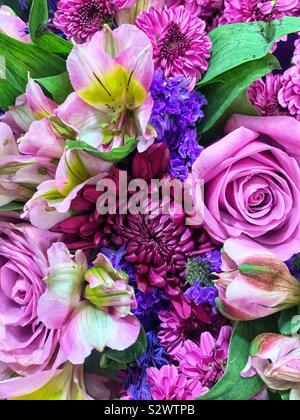 Blumenstrauß voller rosa und lila Rosen und Chrysanthemen und Krokus. Stockfoto