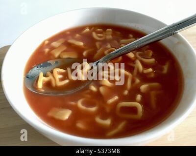 Hilfe auf einem Löffel mit Alphabet Spaghetti buchstabiert Stockfoto