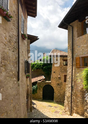 Straße und Häuser des mittelalterlichen italienischen Dorfes Canale di Tenno Stockfoto