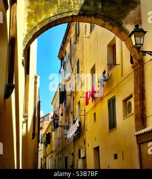 Kleiderreinigung hängend zum Trocknen Außenfenster in italienischem Gelb Gebäude Stockfoto