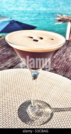 Espresso Martini auf einem Tisch mit Blick auf das Karibische Meer Stockfoto