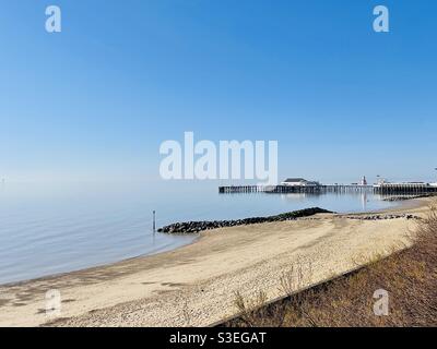 Einsamer Pier und Strand in Clacton on on Sea, Essex. Ein heißer Frühlingstag während der COVID-19-Sperre Stockfoto