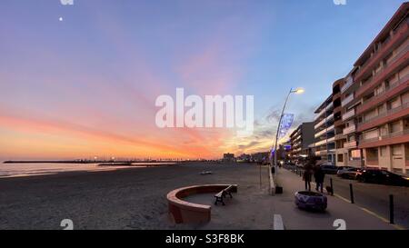 Rot-orangefarbener Sonnenuntergang über dem Strand und der Uferpromenade in Palavas les Flots, in der Nähe von Carnon Plage und Montpellier, Ockitanie, Südfrankreich Stockfoto