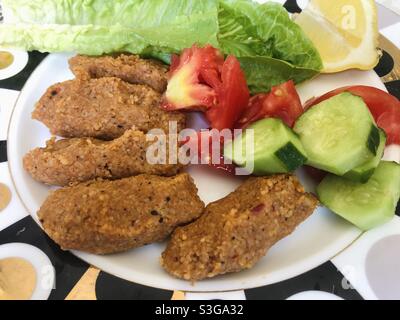 Türkisches veganes Gericht Cig Kofte serviert mit Gemüse und Salat Stockfoto