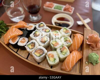Sushi mit Lachs und Thunfisch auf einer hölzernen Bootsplatte in einem japanischen Restaurant in Martigues, in der Nähe von Marseille, Bouches-du-Rhône, Provence-Alpes-Côte d'Azur, Südfrankreich Stockfoto
