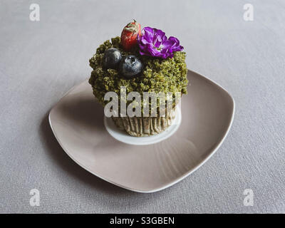 Grüner Cupcake mit Obst. Stockfoto