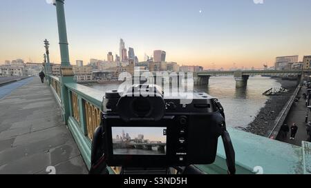 Fotograf macht ein Foto in London in Richtung der Stadt London über die Themse, Stockfoto