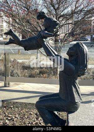 Ein kleiner Stadtpark in der Nähe der Innenstadt von Salt Lake City, Utah, USA. Inmitten des Geländes finden sich liebenswerte Skulpturen von Kindern, die im Park „spielen“ und den kleinen Park mit kindlichen Freuden und Begeisterung ausloten. Stockfoto