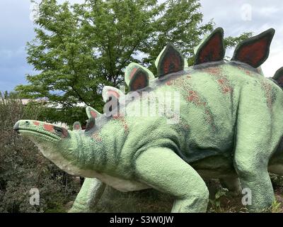 Der Innenhof im Dinosaur Museum in Vernal, Utah, USA, hat verschiedene große Dinosaurier-Statuen, die auf dem Gelände platziert sind, um die Gäste, vor allem die Kleinen, zu erfreuen. Stockfoto