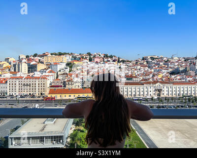 Junge Frau blickt auf Lissabon im portugiesischen Alfama-Viertel Stockfoto