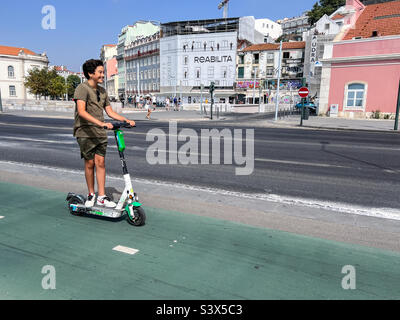 Junger Mann auf seinem Elektroroller in Lissabon, Portugal Stockfoto