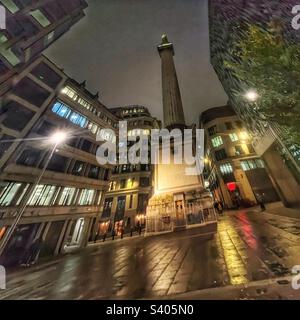The Monument in London - built between 1671 and 1677 to commemorate the Great Fire of London and to celebrate the rebuilding of the City seen at night Stock Photo